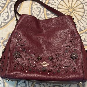 Beautiful Burgundy Coach leather purse. Has raised flower accents
